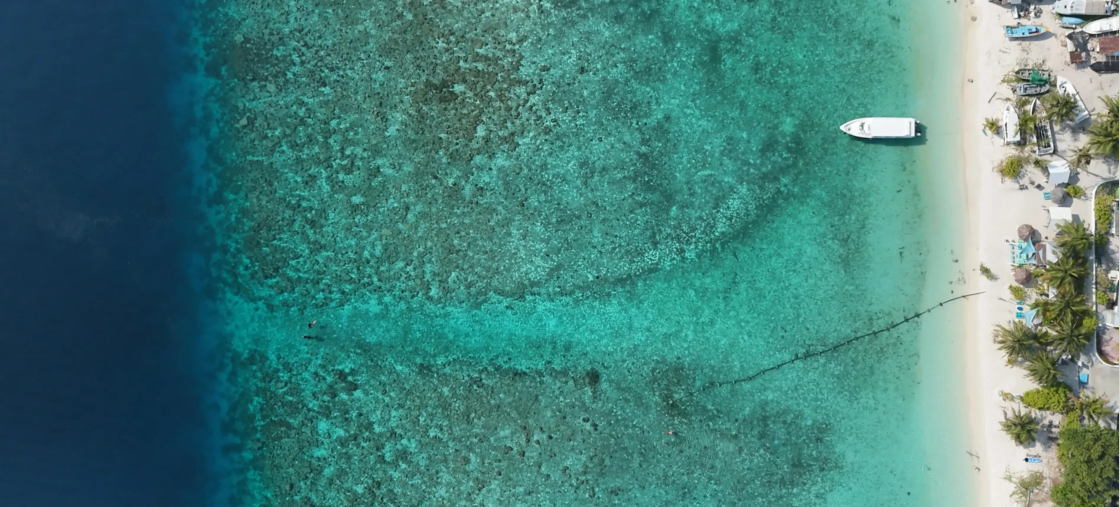 Aerial view of a speedboat docked at a Maldivian island