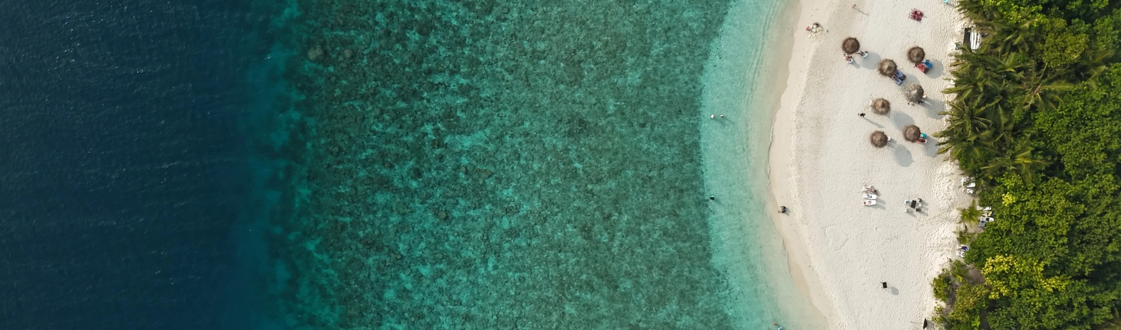 Aerial view of a Maldivian island with turquoise waters